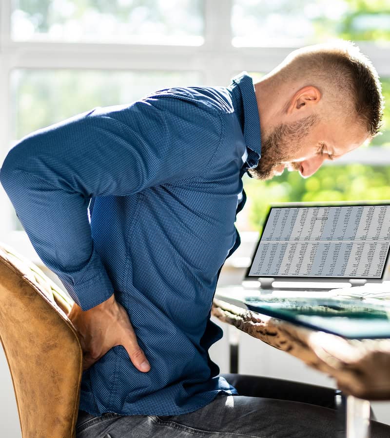 Man sitting with lower back pain